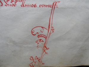 AA7 folio 16 recto : Grotesque terminant la hampe d'une lettre au bas d'une page